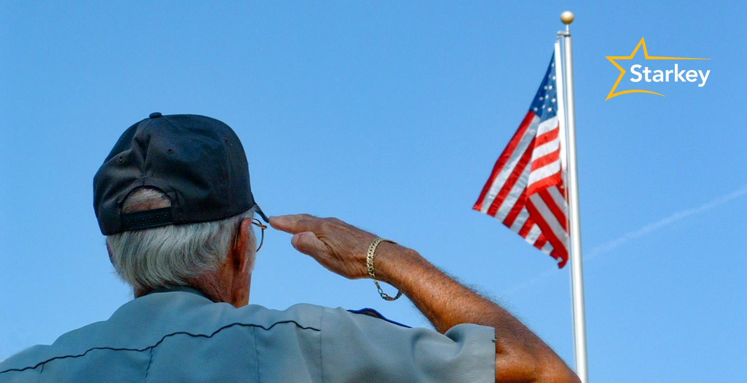 Image of senior male veteran saluting an American flag